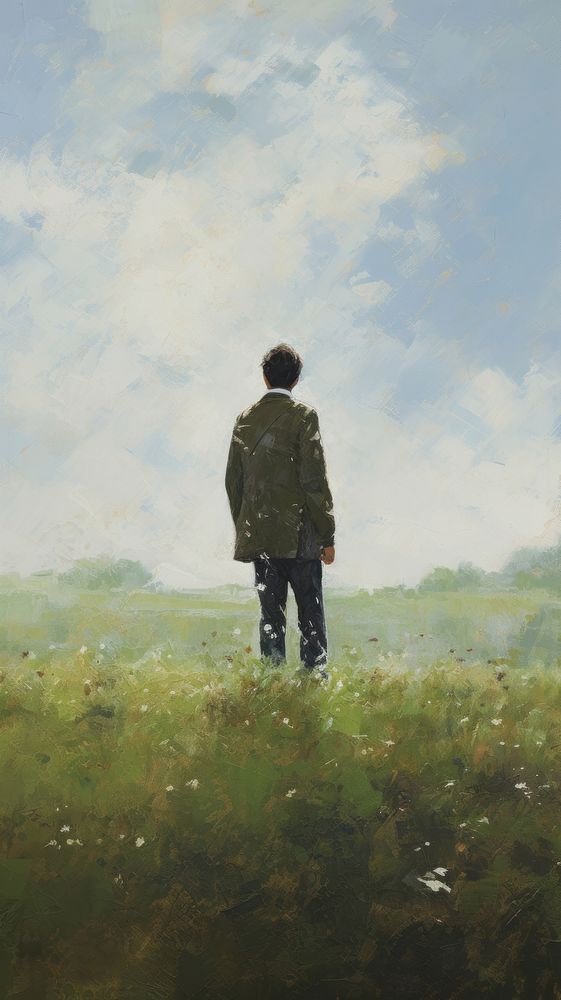 Young man on the grass field on the hill in spring painting standing outdoors.
