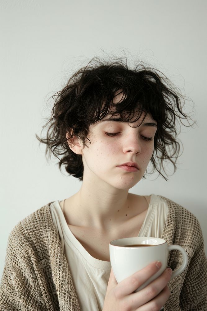 A Tired sleepy woman coffee cup portrait.