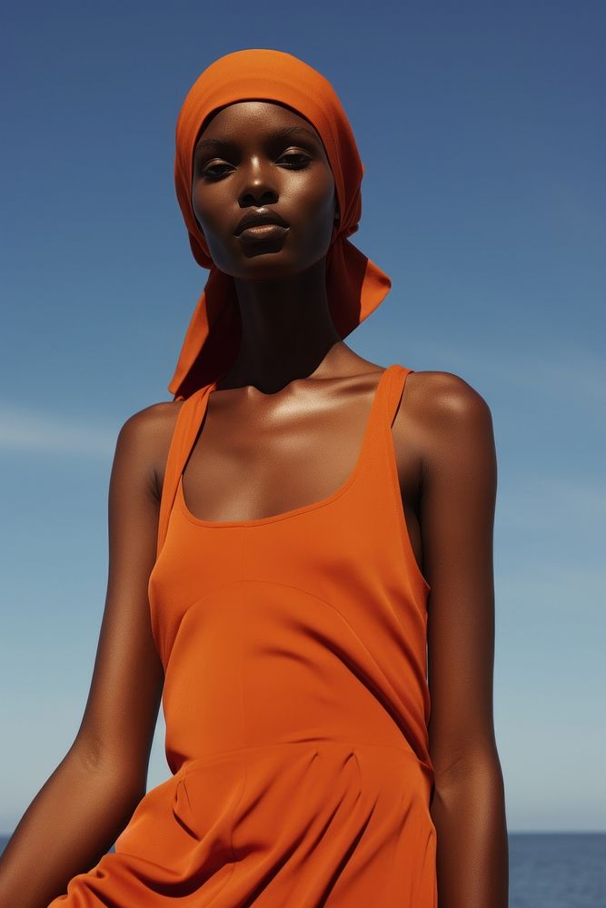 A black woman wearing orange modern minimal cloth photography portrait fashion.