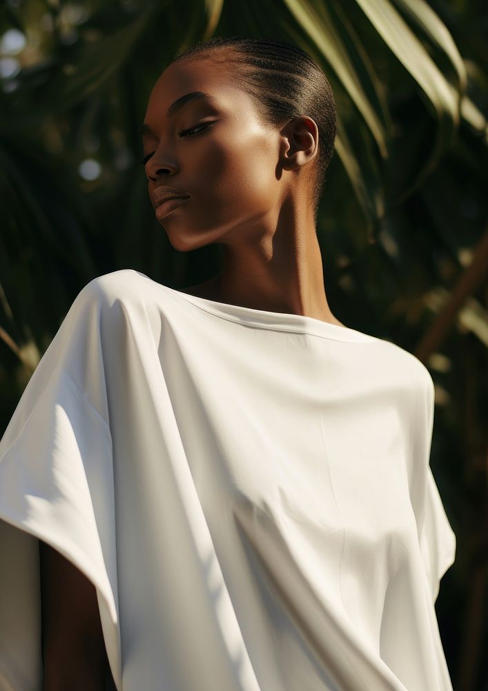 A black woman wearing white modern minimal cloth photography portrait fashion.