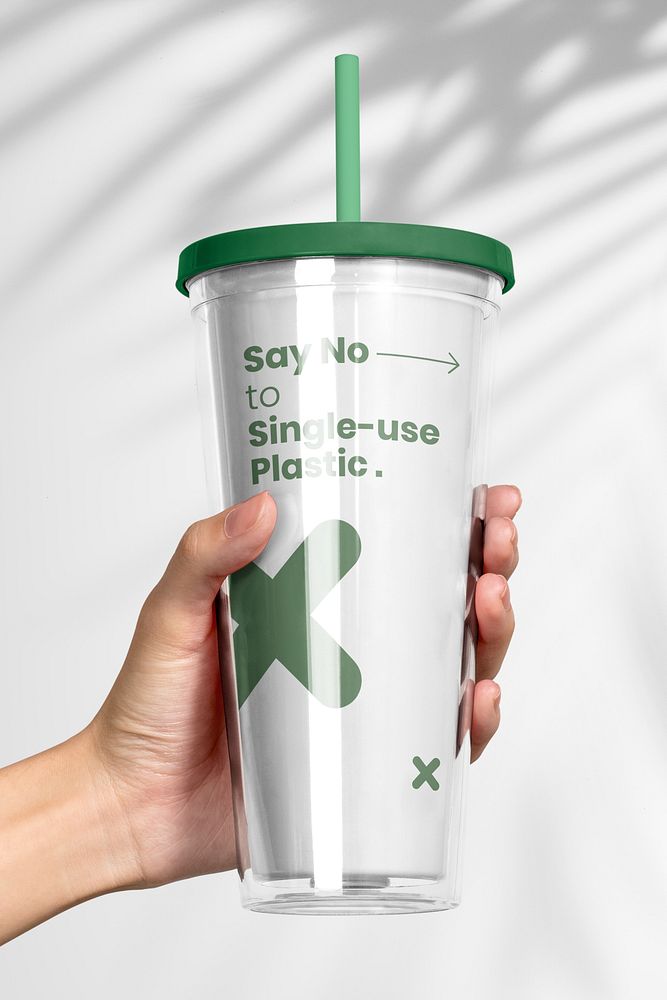 Hand holding plastic tumbler