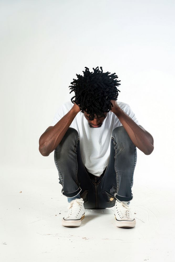 Depressed young black man hiding head in hands white white background disappointment.