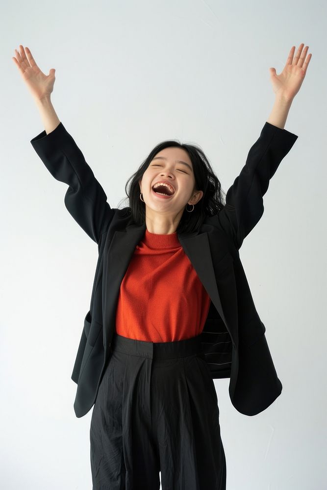 Excited Asian woman raised her hands up shouting white background achievement.