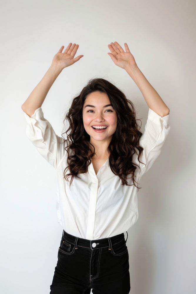 Excited latina woman raised her hands up smile white background triumphant.