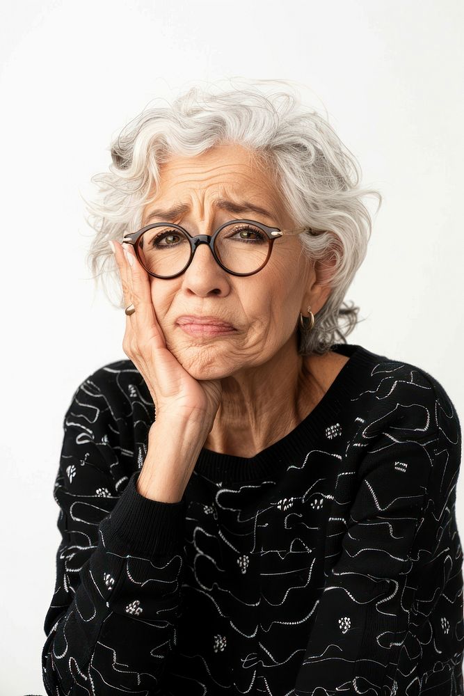 Senior woman touching cheek with hand portrait glasses adult.