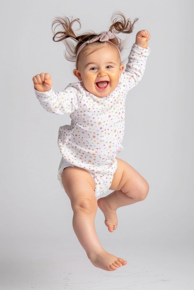 Baby girl jumping portrait happy photo.
