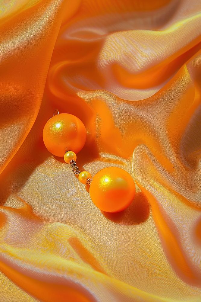 Photography of earrings backgrounds jewelry orange.