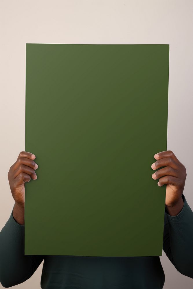 Man holding blank olive green poster