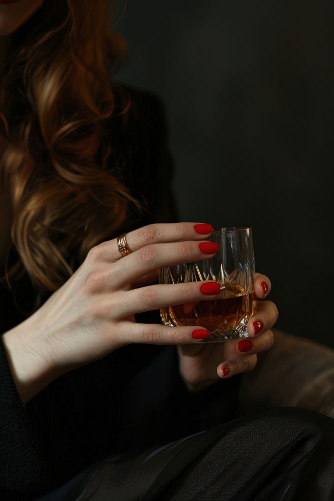 Woman hand with red nail hold a glass of whisky drinking finger adult.