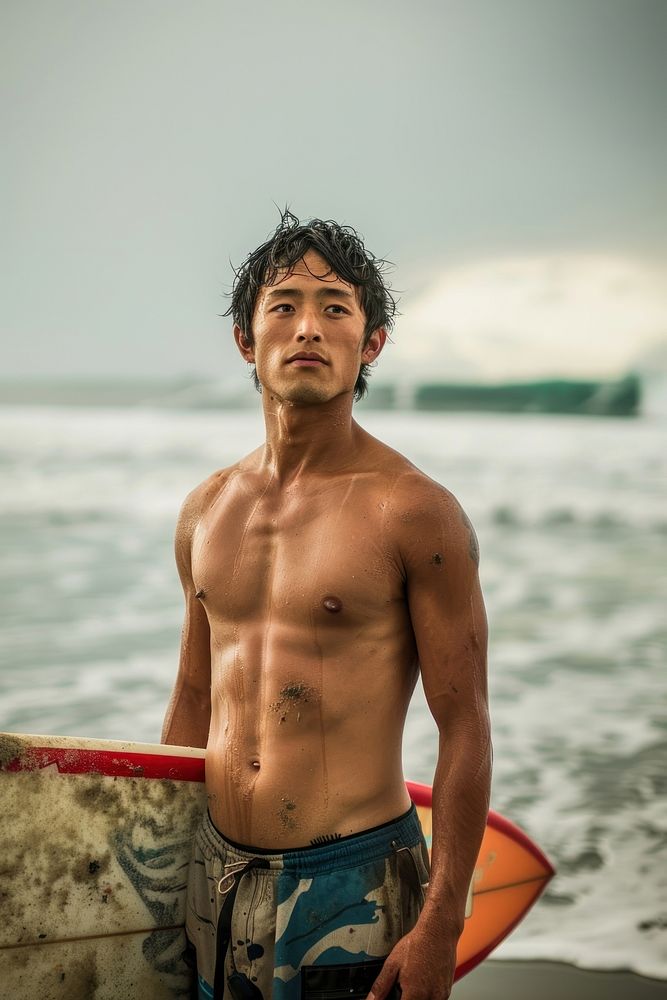 Japanese surfer with a surfboard at the beach outdoors sports day.