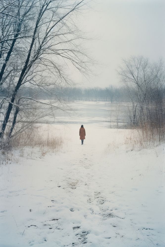 Woman walking in snow land landscape blizzard.