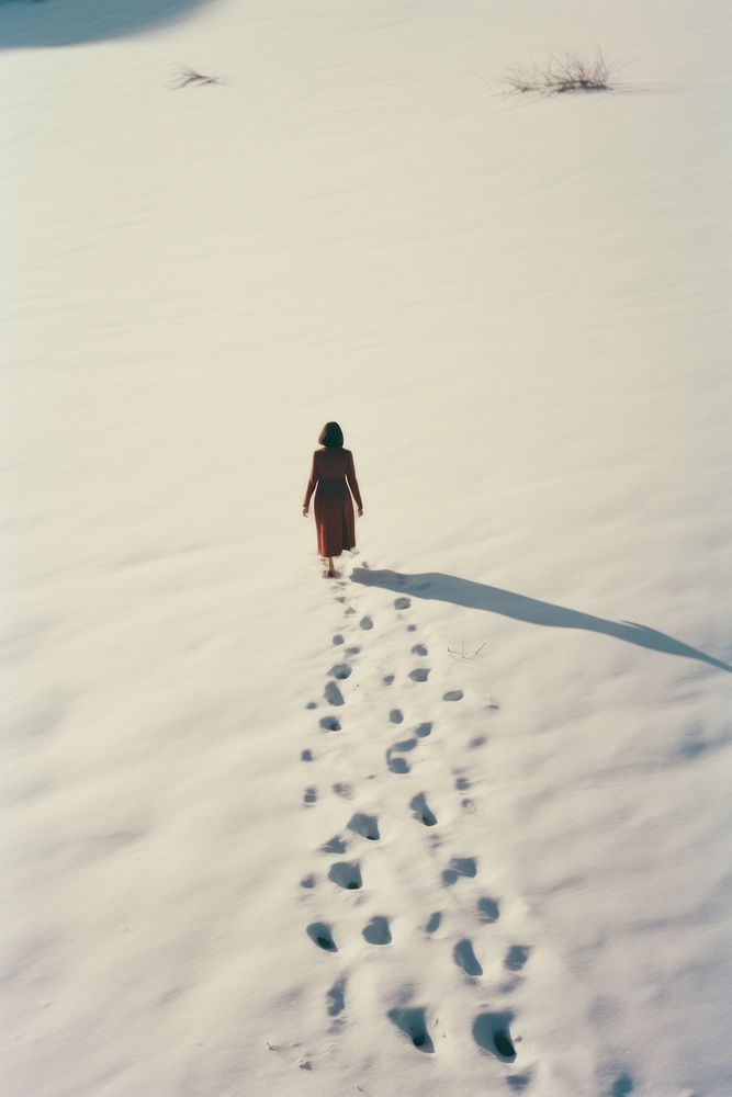 Woman walking in snow photography landscape outdoors.