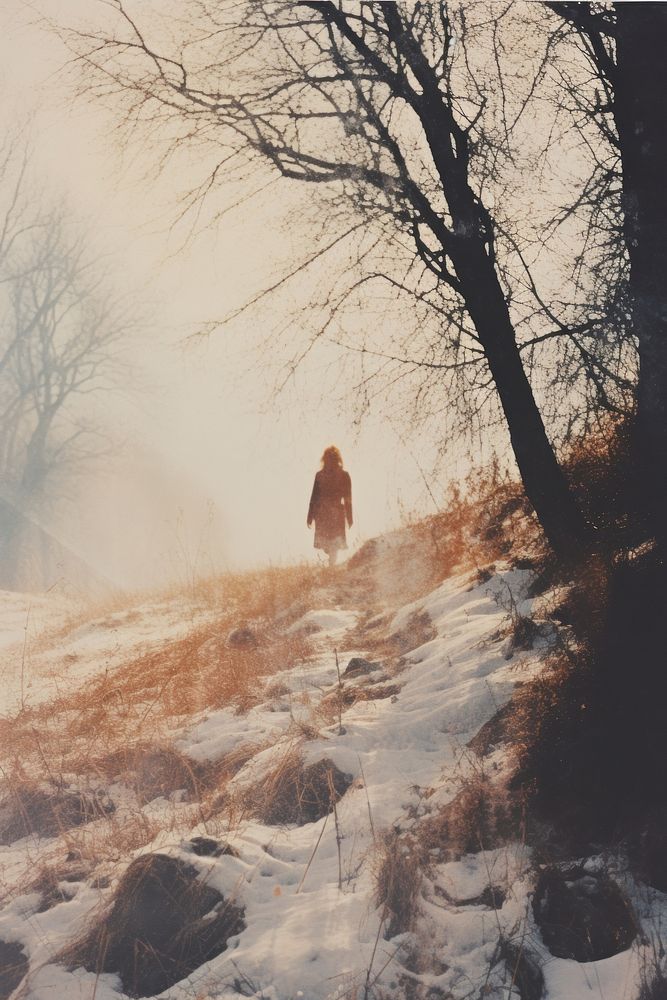 Woman walking in snow landscape photography sunlight.