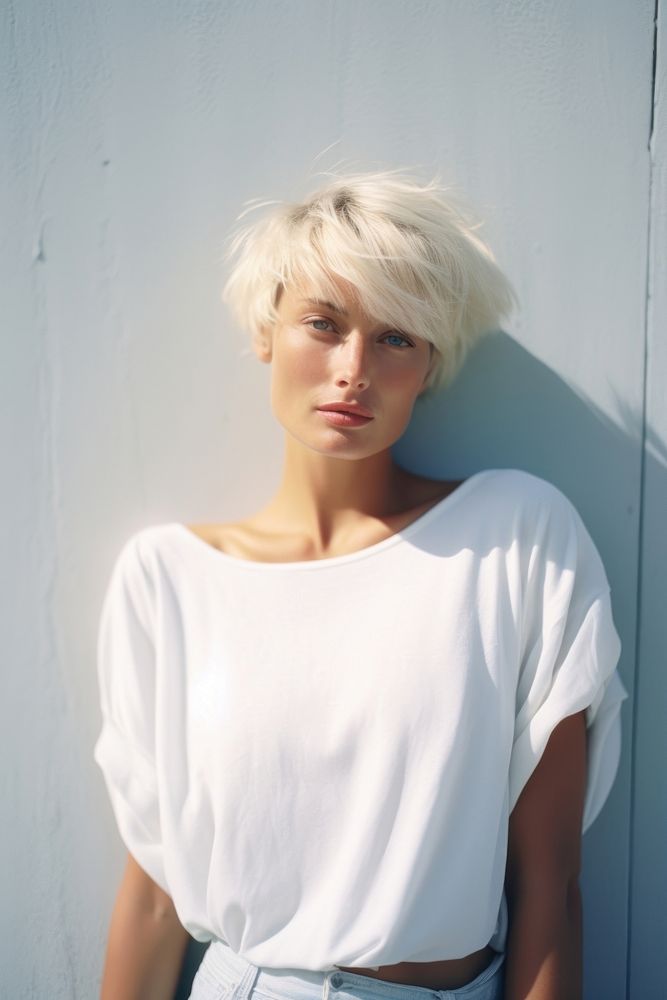 A mature woman wear white clothing apparel blonde.