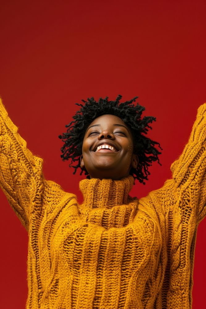 Black woman sweater smiling yellow.