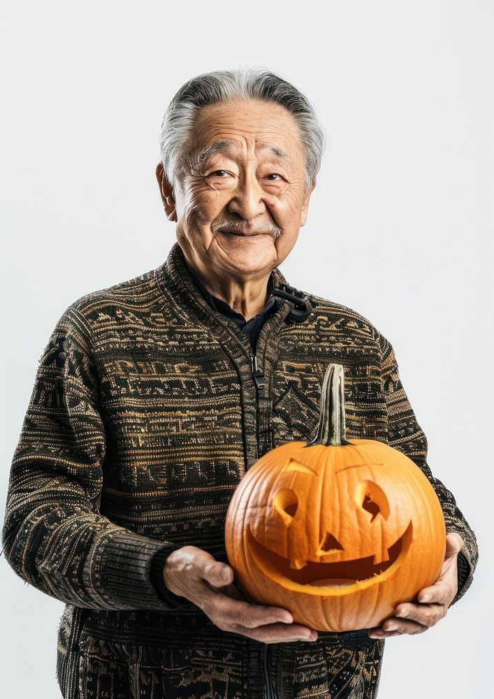 Photo of an elder asian man halloween jack-o-lantern festival.