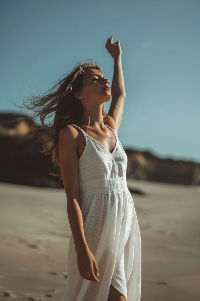 Woman wearing white long dress triumphant beachwear clothing.