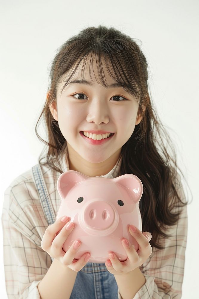 Korean girl holding piggy bank smile investment happiness.