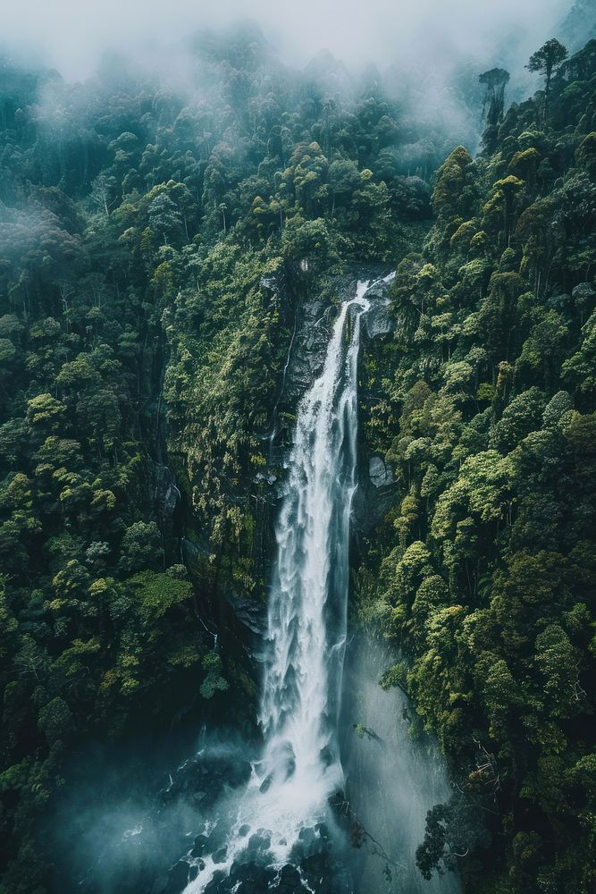 Aerial top down view of stunning waterfall outdoors nature forest.