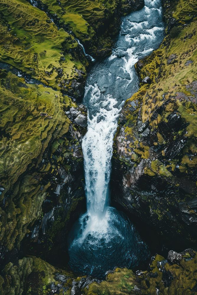 Aerial top down view of stunning waterfall outdoors nature stream.