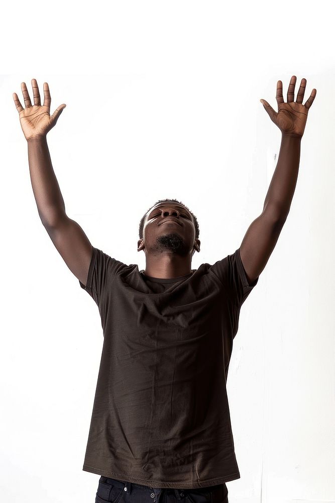 Black young adult man raising hands triumphant gesturing hairstyle.