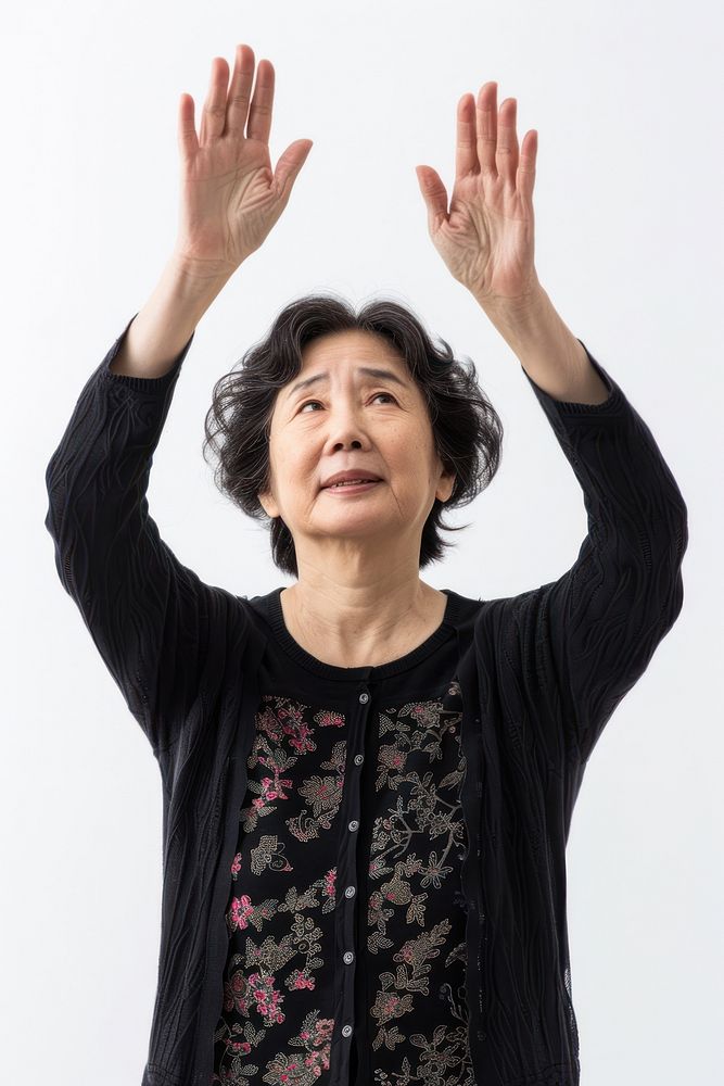 Japanese middle age woman raising hands adult gesturing happiness.