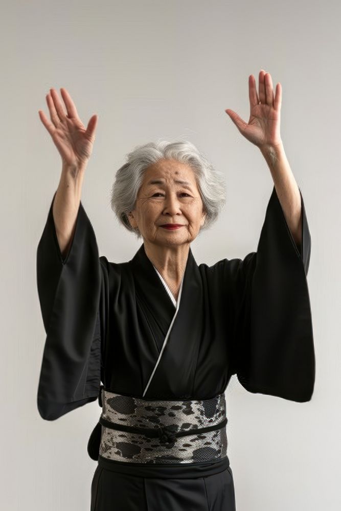 Japanese senior woman raising hands adult robe spirituality.