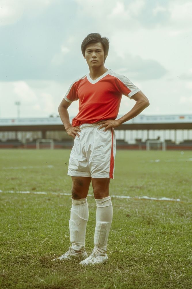 Thai male football player standing grass competition.