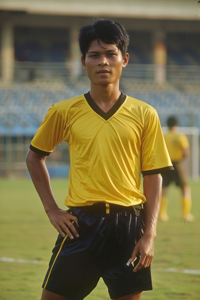Thai male soccer player football grass determination.