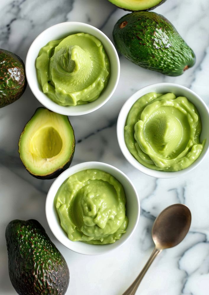 Baby food avocado spoon guacamole.