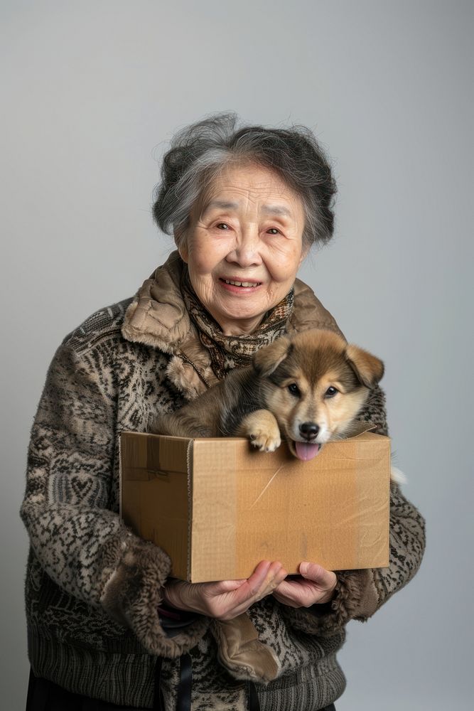 Woman holding box with puppy photo happy photography.