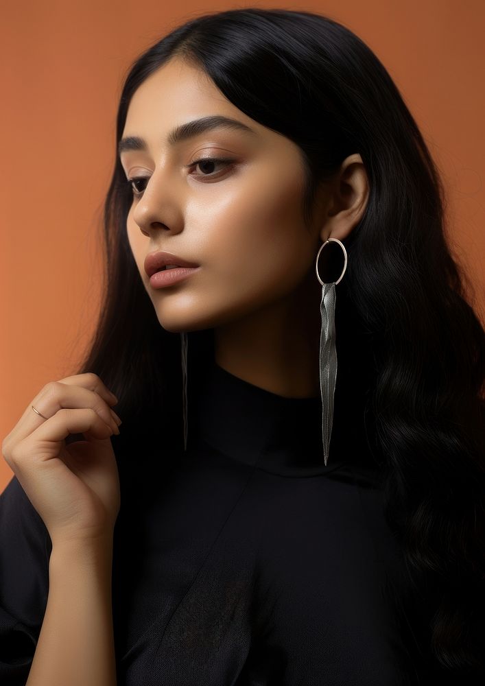 Latinx woman holding flower volumetric photography earring.