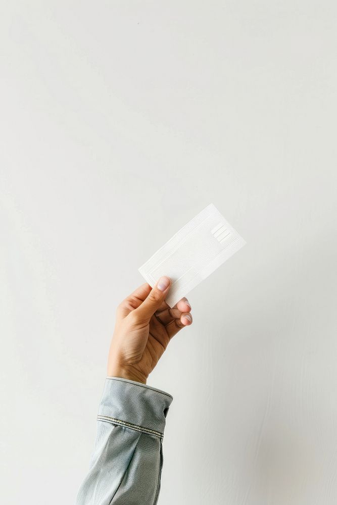 Hand holding receipt white paper white background.