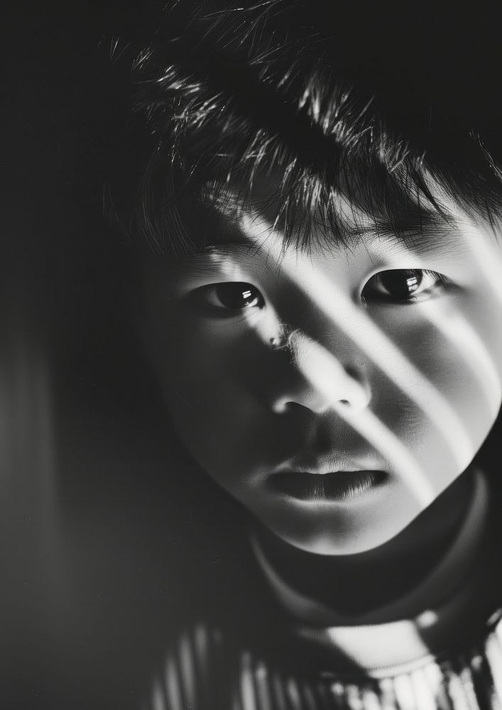 Analog black and white film photography of an asian kid portrait worried person.