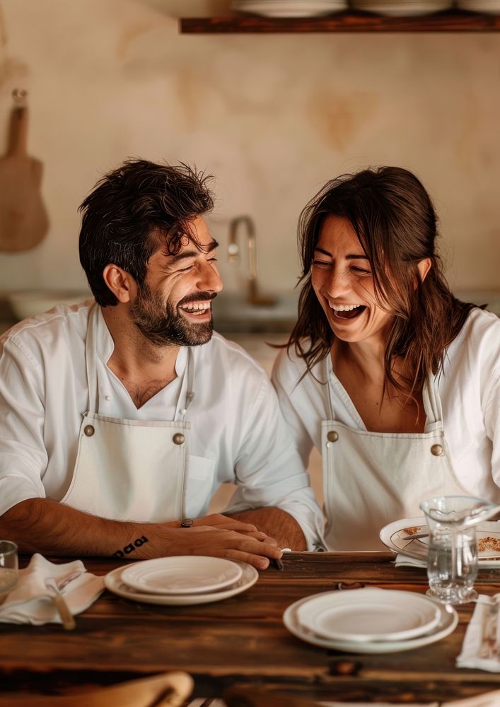 An Italian chef and his wife laughing plate person.
