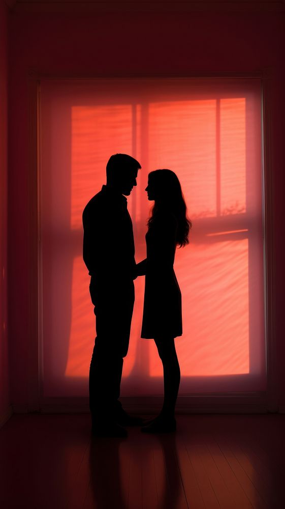 Silhouette of man and woman indoors backlighting romantic.