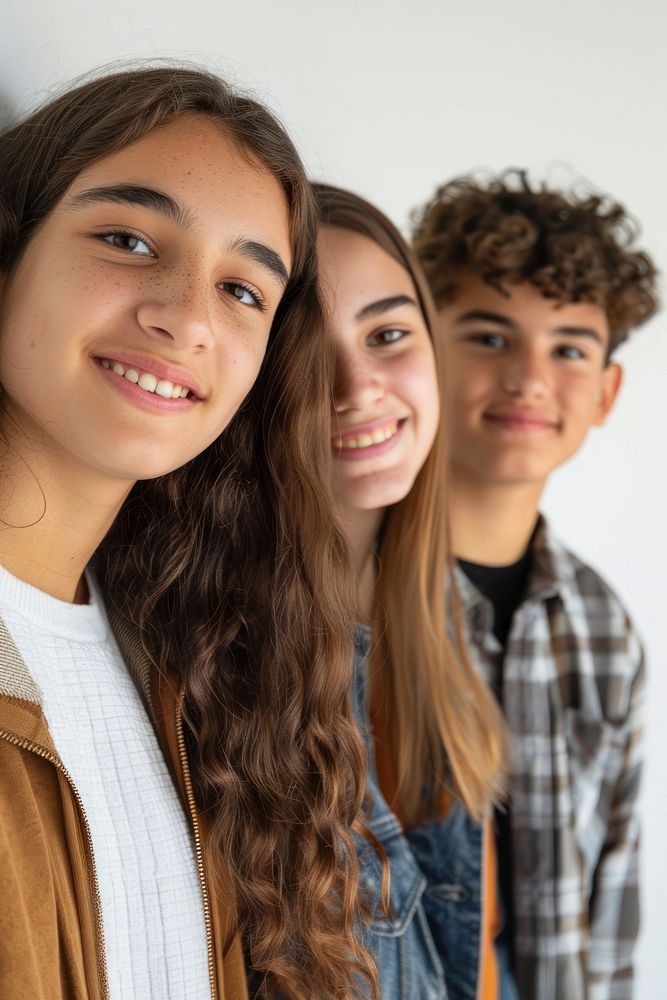 Smiling teenage women and men standing in front the wall clothing apparel person.
