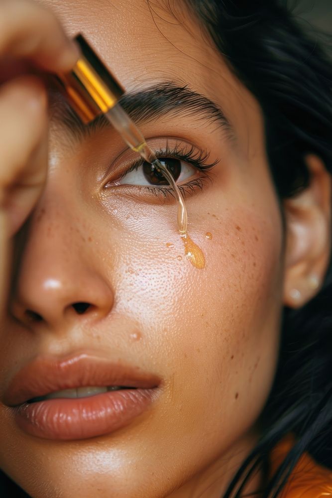 Woman face applying serum cosmetics adult skin.