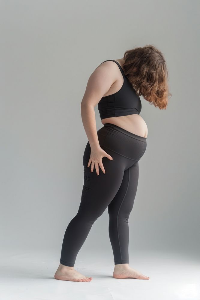 Young bob hair chubby woman stretching after yoga clothing apparel spandex.