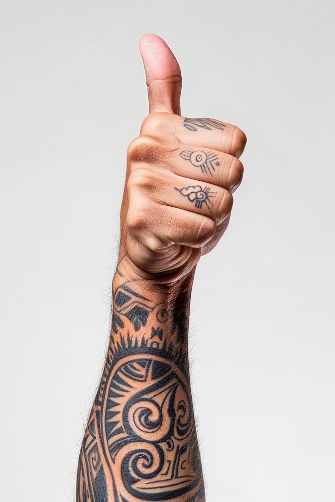 Hand holding up with Maori tattoo giving a thumbs up finger person human.