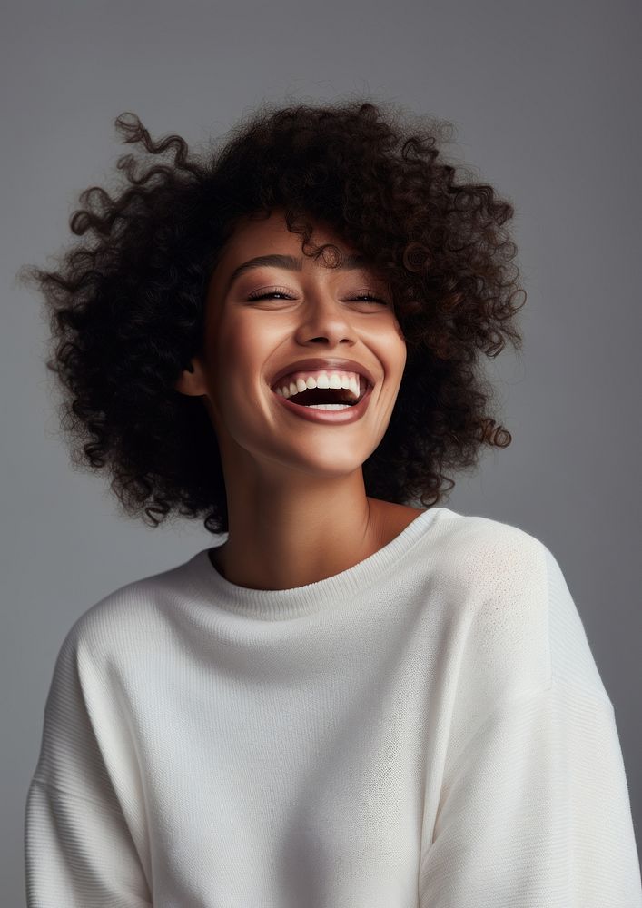 Black woman in white sweater happy laughing person.