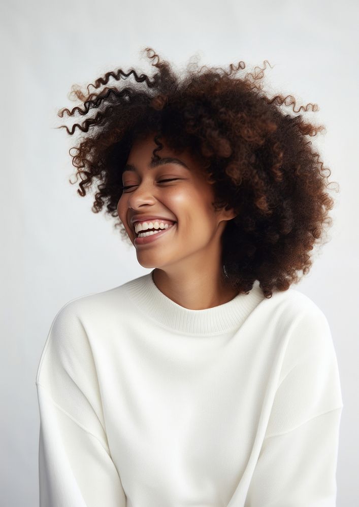 Black woman in white sweater happy laughing person.
