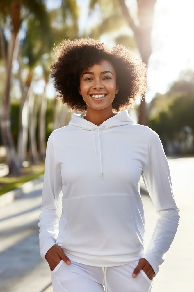 Black woman wearing white sport wear happy sweatshirt clothing.