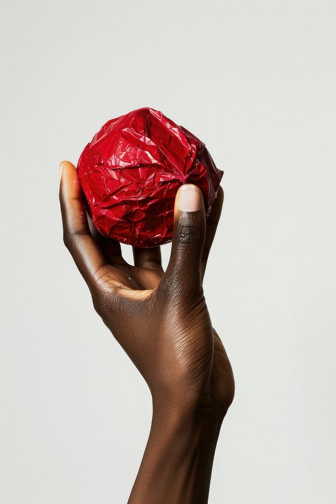 The crimson crumpled paper ball produce woman vegetable.