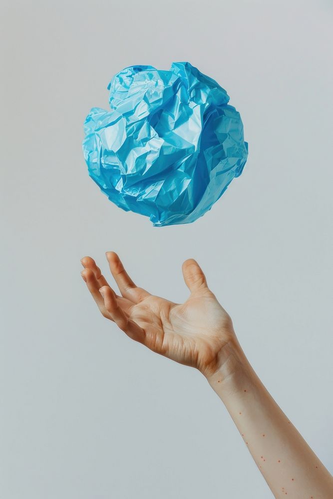 Freckled hand hurled the cerulean crumpled paper ball plastic blossom balloon.