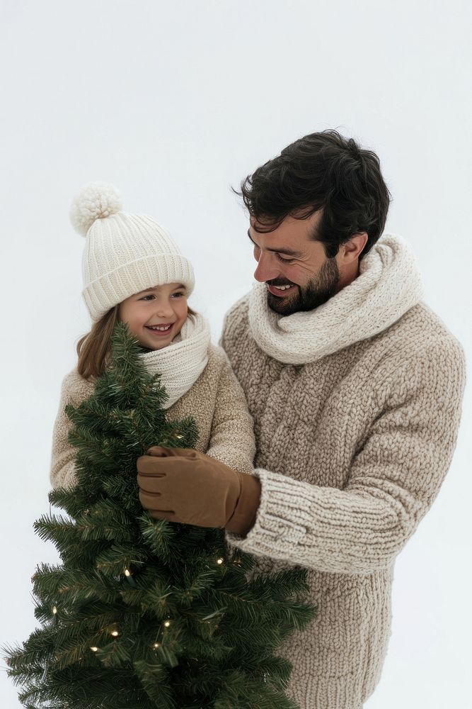 A 6 years old girl with dad buy christmas tree together clothing smiling lights.