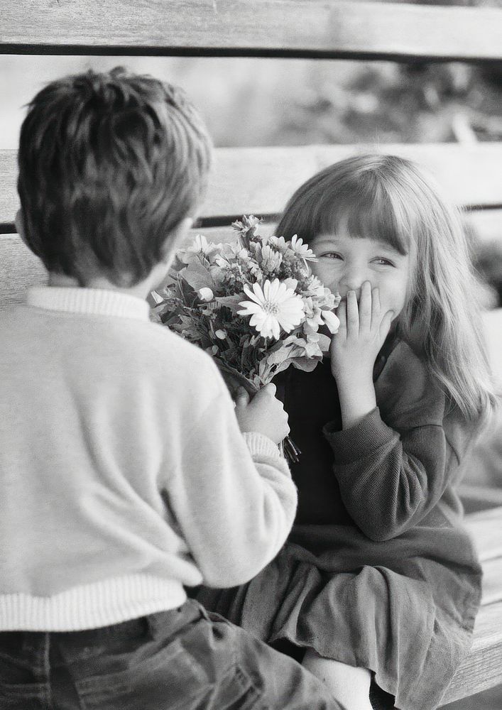 Little boy standing his back to camera and hiding flower bouquet flowers bench children.