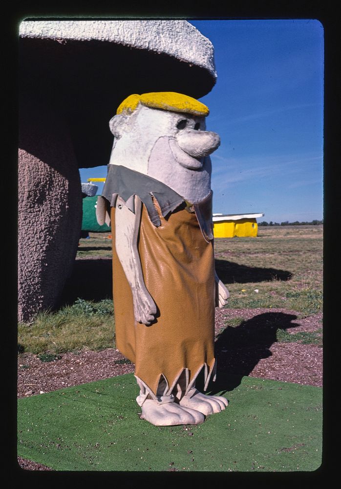 Barney Rubble statue, Bedrock City, Routes 64 and 180, Valle, Arizona (1987) photography in high resolution by John…