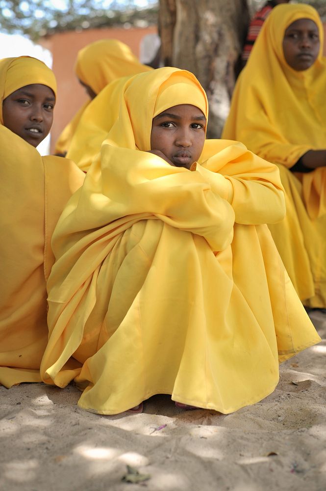 Young girls watch a football game being played outside of their school during breaktime at a center run by Dr. Hawa in the…