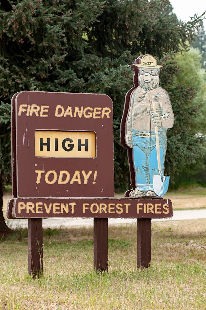 U.S. Department of Agriculture Forest Service Smokey Bear sign informs people that today's fire danger level is high, near…